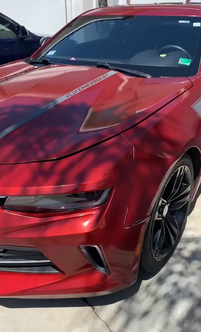 After — Red Chevrolet Camaro hood and front fender — dusty, faded finish, then deep candy-red gloss